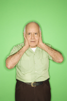 Man pressing his hands over his ears